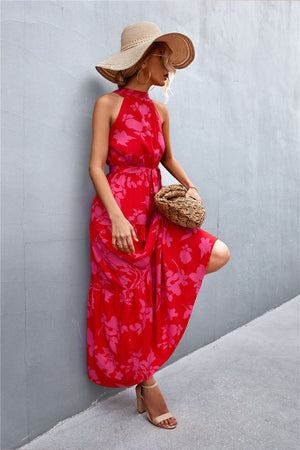 Red floral print halter neck maxi dress with tiered skirt.