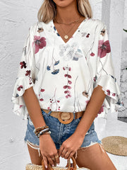 White floral blouse with lace trim and bell sleeves