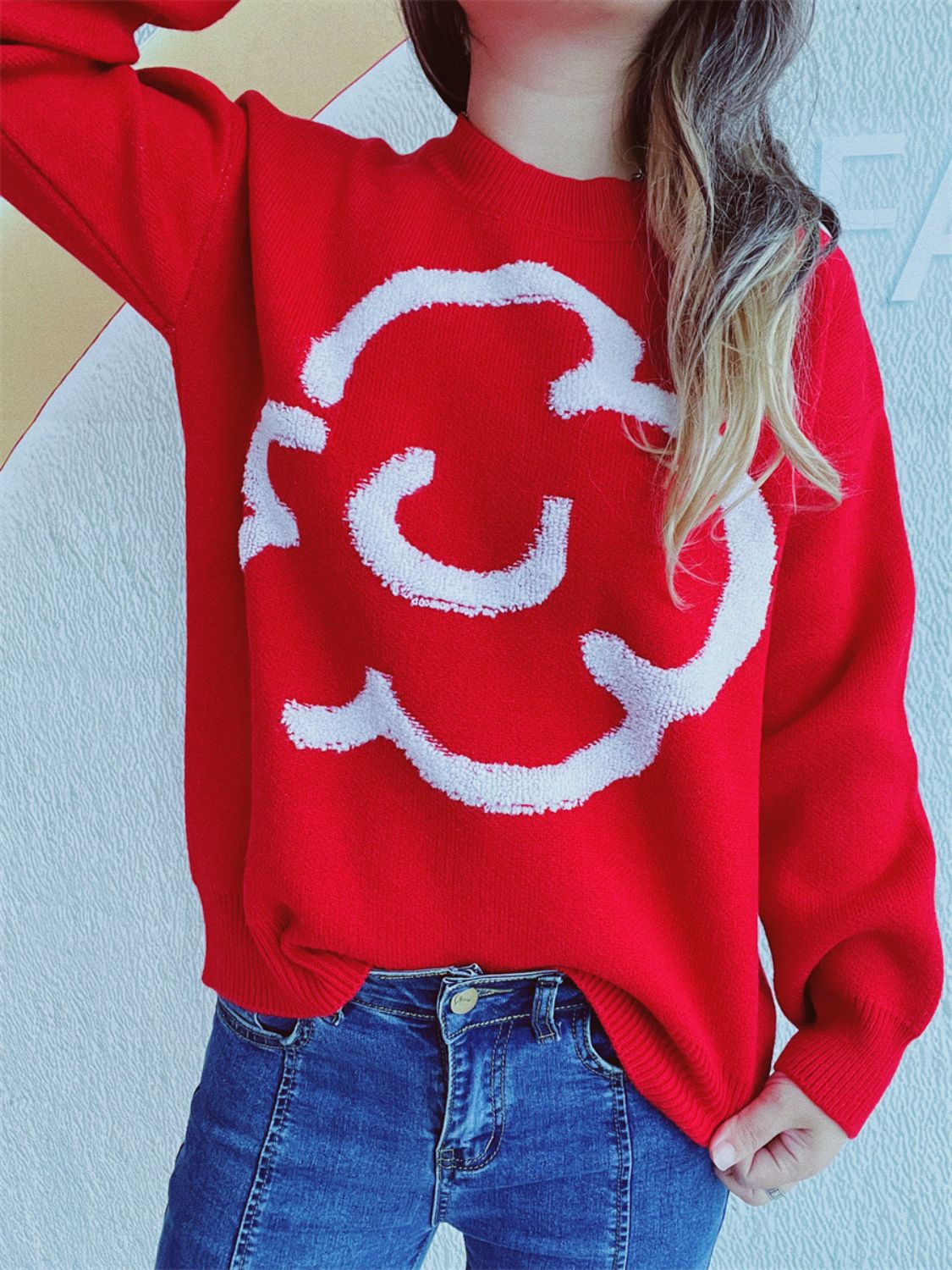 Red acrylic sweater with white cloud intarsia pattern, crew neck, long sleeves.