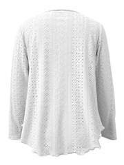 White eyelet blouse with scalloped hem and long sleeves.