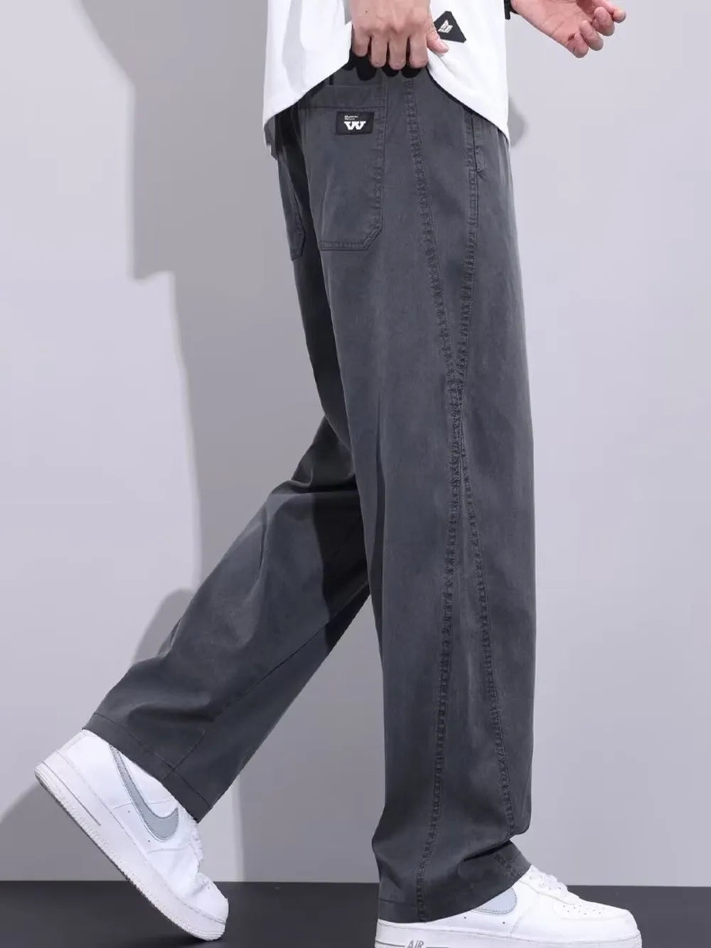 Men's grey relaxed fit sweatpants with drawstring and pockets.