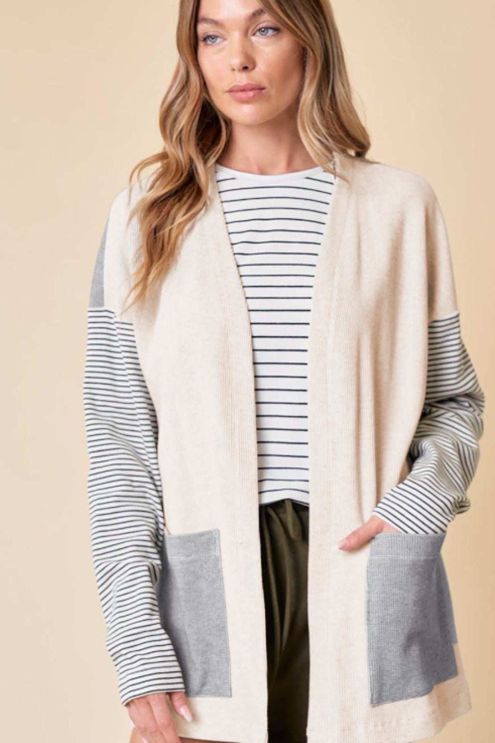 Colorblock stripe sleeve cardigan in light gray with front pockets and a relaxed fit.
