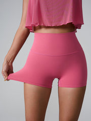 Deep Pink active shorts with high waist and sculpted pocket detail, showing stretch.