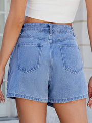 Light blue denim skort with wrap effect and angled seams, featuring back pockets.