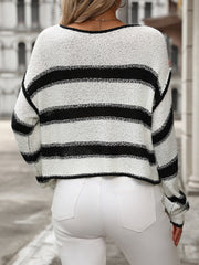 Horizontal stripe knit cropped sweater in black and white acrylic, with a crew neck and long sleeves.
