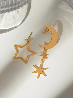 Gold celestial starburst drop earrings with moon detail.