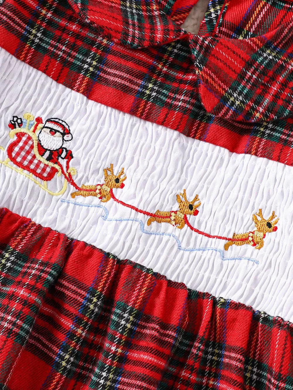 Baby dress with red plaid, smocked white bodice, and Santa in a sleigh embroidered with reindeer.