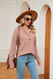 Textured henley hoodie in coral with drop shoulder and button neckline.