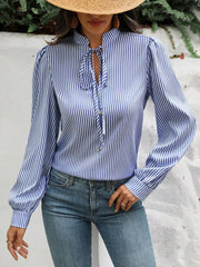 Blue striped blouse with puffed sleeves, keyhole neckline and tie detail