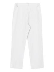 White relaxed fit sweatpants with textured fabric and a back pocket.