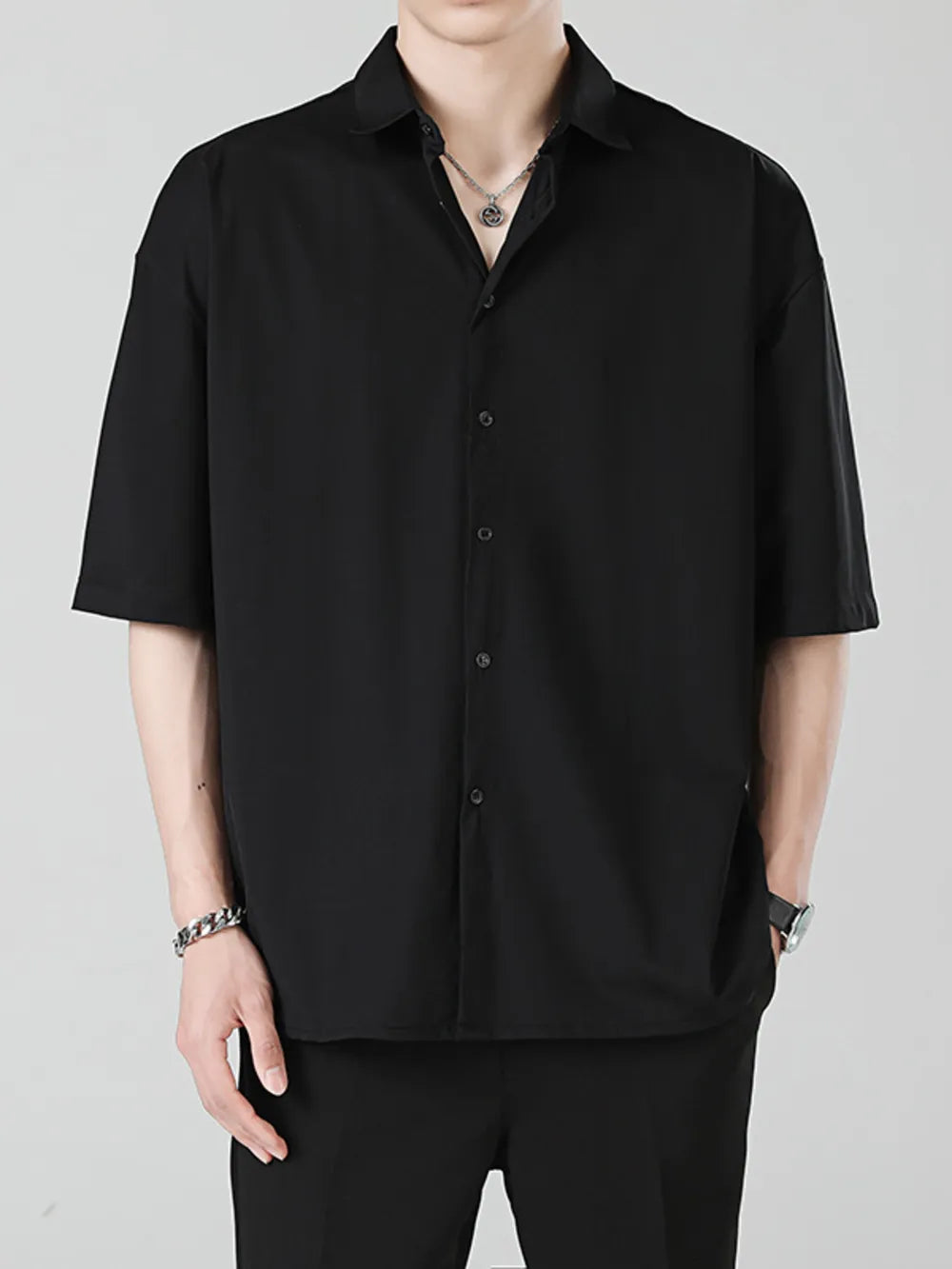 Men's black oversized short sleeve button-up shirt with a spread collar.