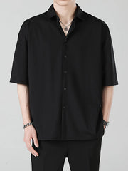 Men's black oversized short sleeve button-up shirt with a spread collar.