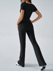 Black loungewear set with ruched waistband and flared pants.