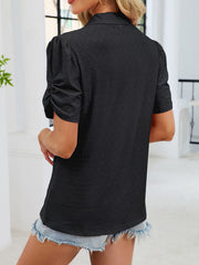Black eyelet ruched short sleeve blouse with a collared neckline.