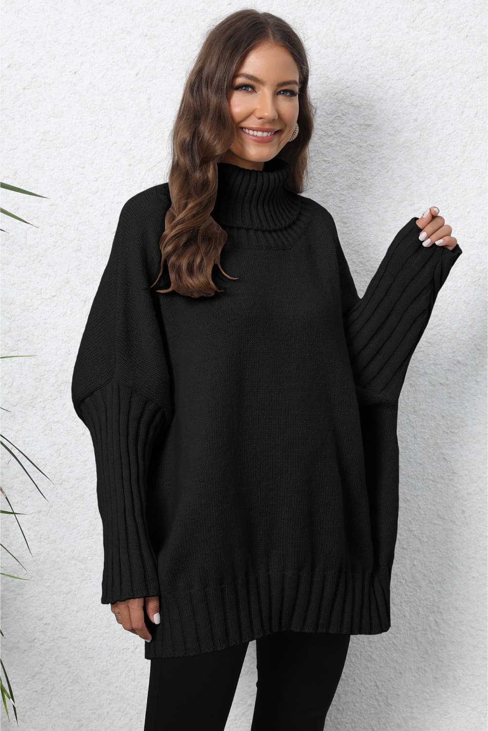 Black ribbed turtleneck sweater with batwing sleeves and a relaxed fit.