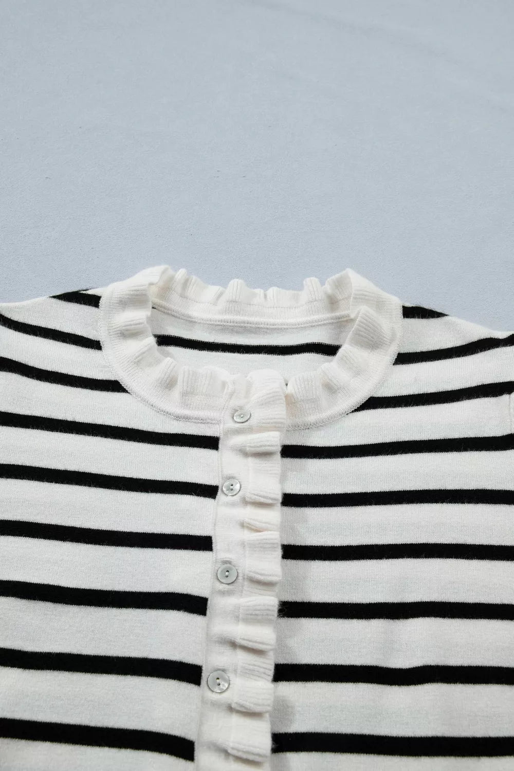 Chic striped maternity cardigan with ruffle trim and buttons.