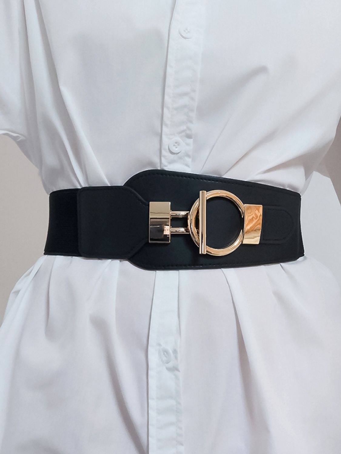Black elastic belt with sculpted gold buckle and hardware