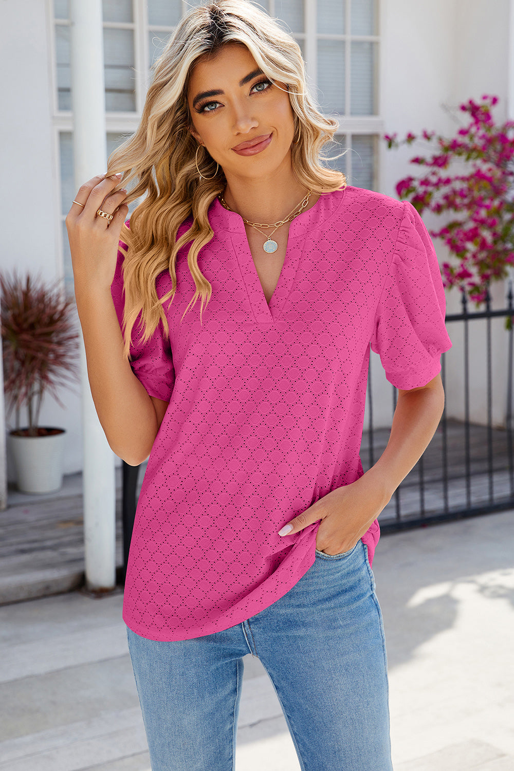Hot Pink eyelet V-neck blouse with puff sleeves and a textured pattern.