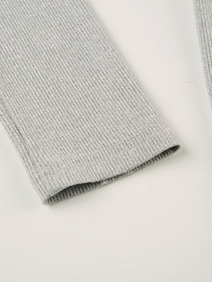 Gray ribbed long sleeve romper detail showing textured fabric and hem