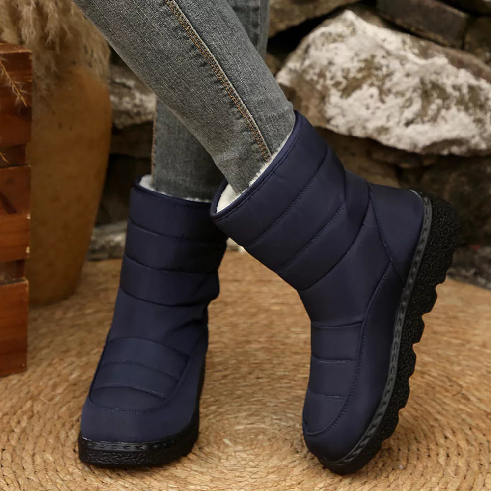 Blue quilted round toe platform boots with a chunky sole and adjustable strap.