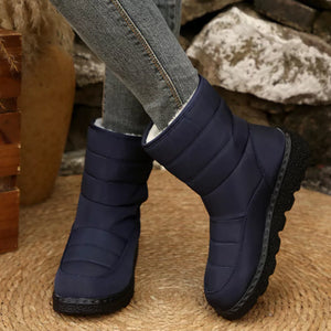 Blue quilted round toe platform boots with a chunky sole and adjustable strap.