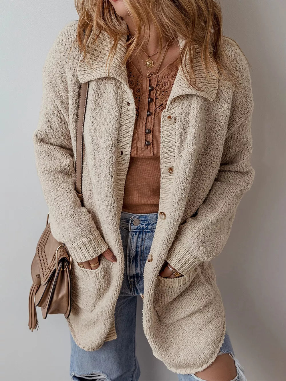 Beige textured button-up cardigan with pockets and a collared neckline.