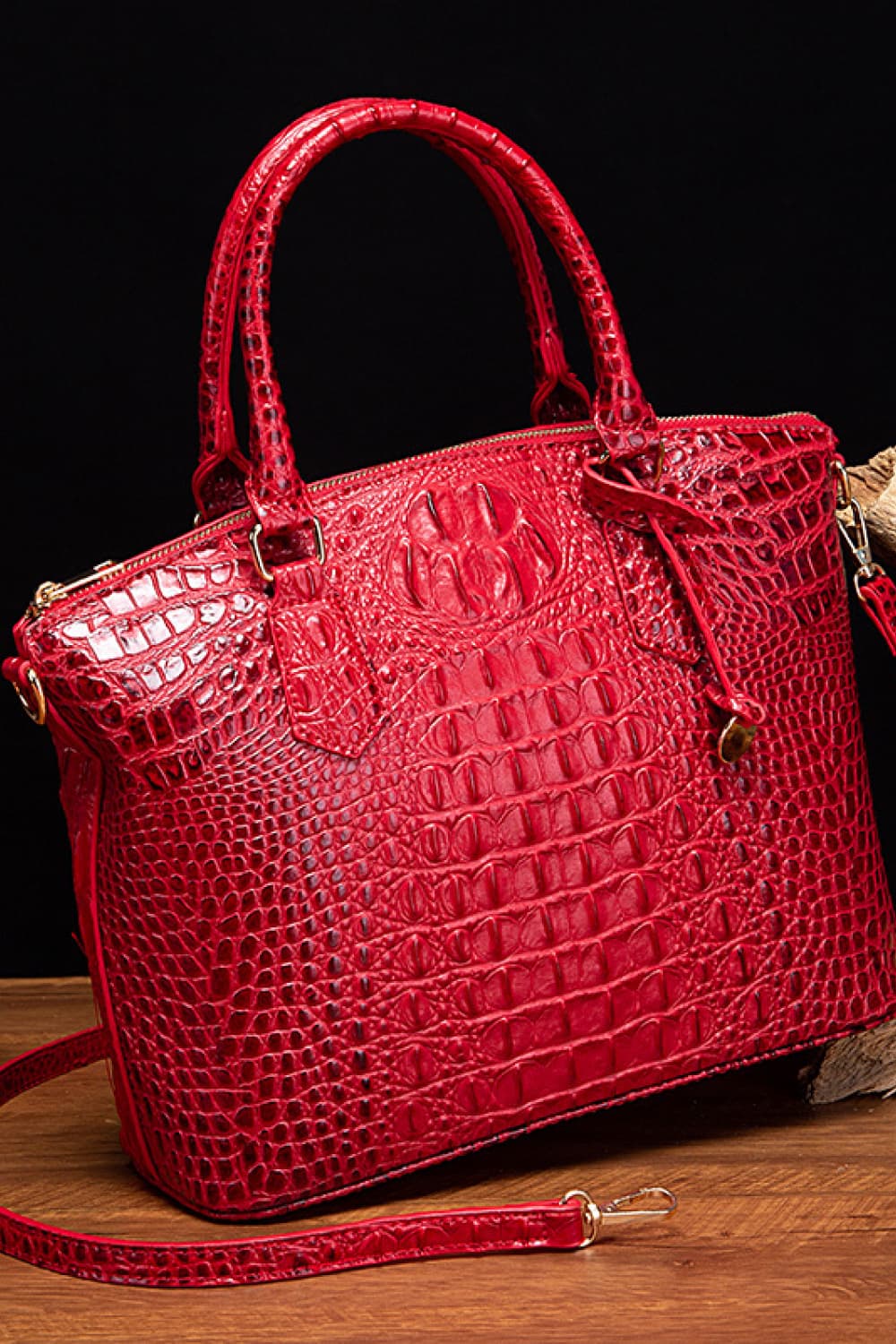 Red crocodile embossed satchel with top handle and gold hardware detail.