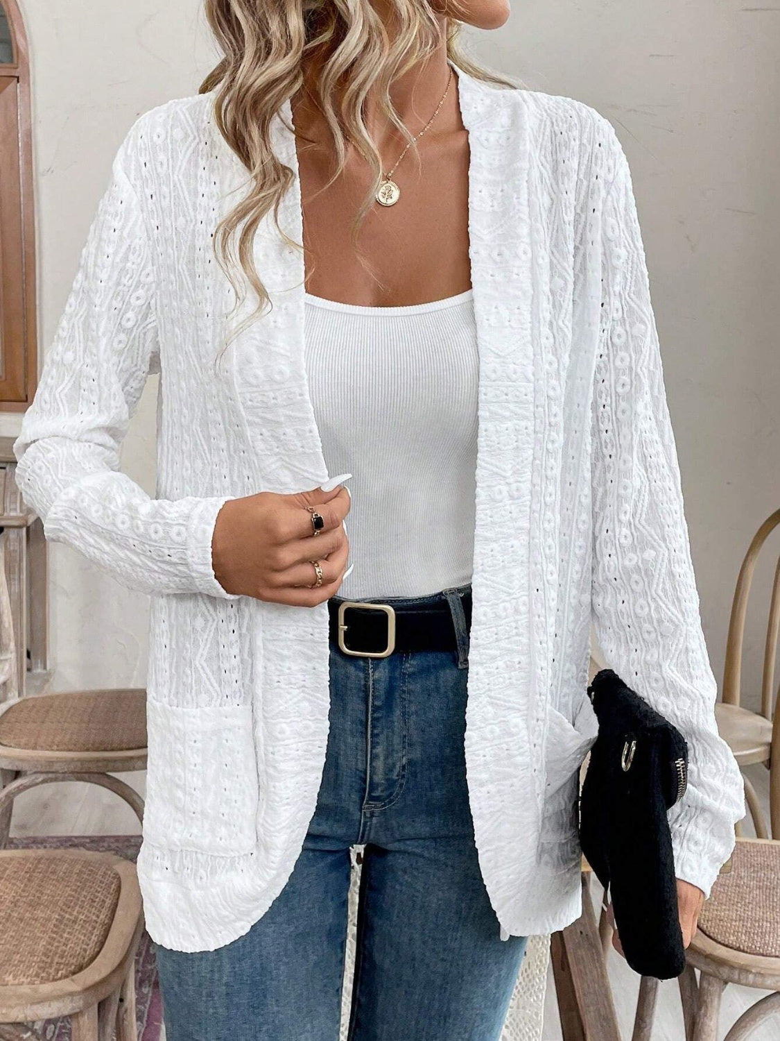 White open-weave embroidered cardigan with pockets, open front, and long sleeves.