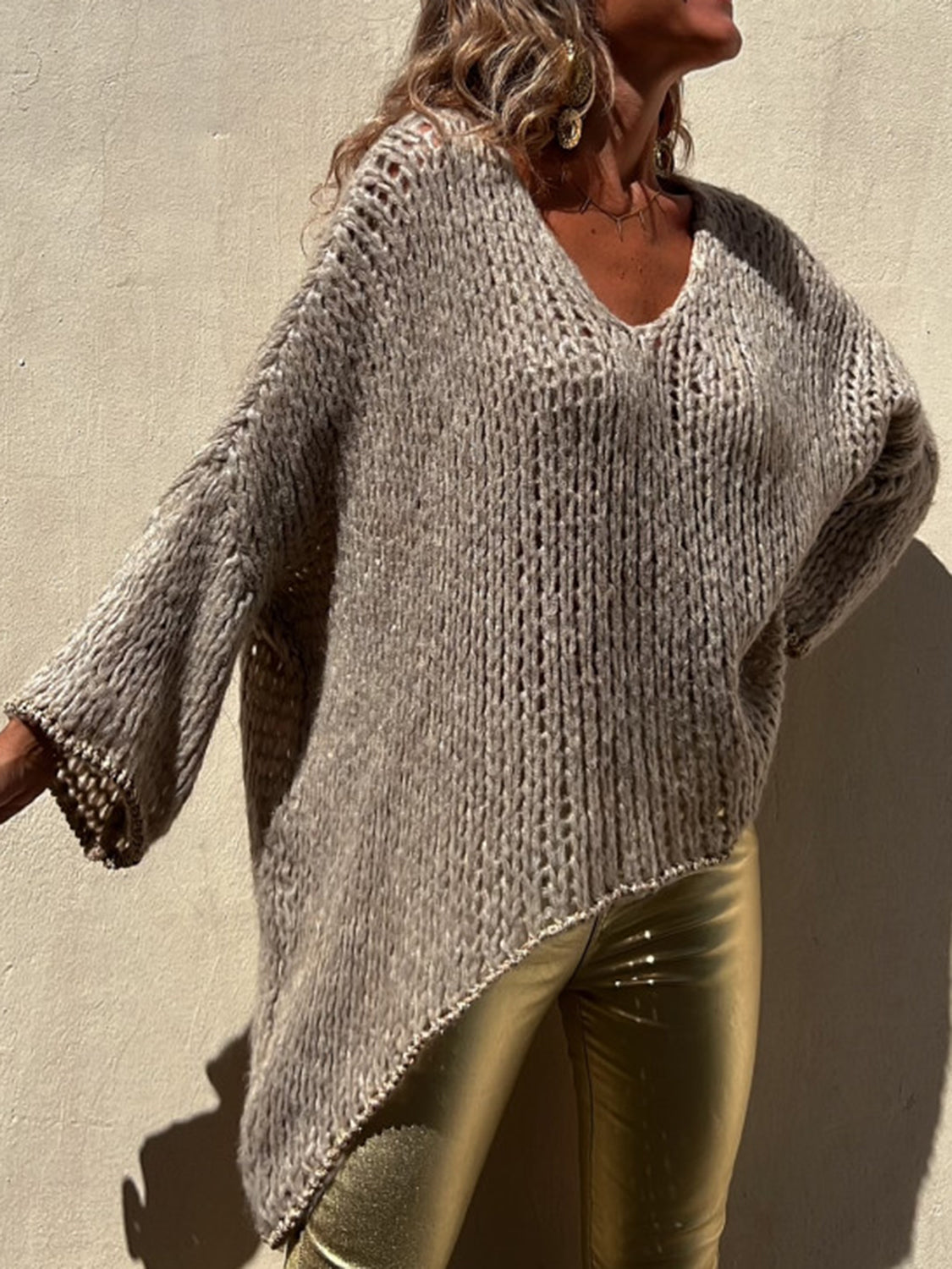 Camel open knit sweater with asymmetric hem and beaded trim detail.