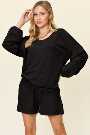 Black waffle knit lounge set with blouson sleeves and v-neck top and matching shorts.