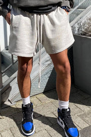 Light gray fleece drawstring jogger shorts with pockets and a relaxed fit.