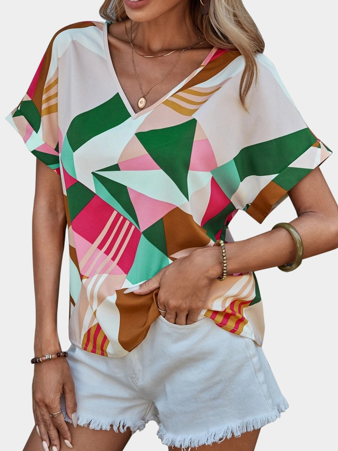 Geometric print V-neck blouse in multicolor with short sleeves.