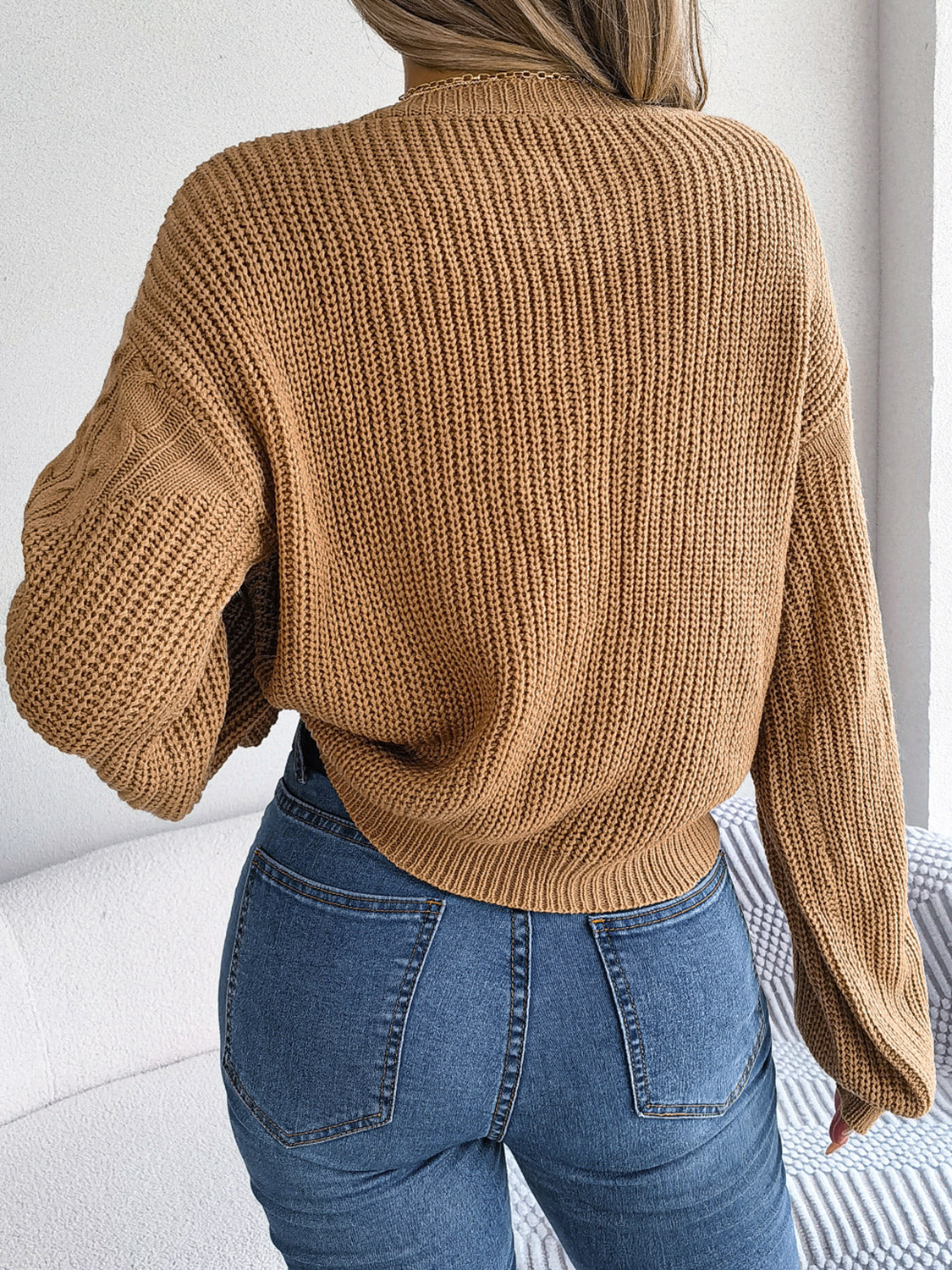 Textured cable knit drop shoulder pullover in taupe with balloon sleeves.