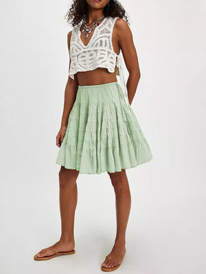 Sage green tiered drawstring mini skirt with a ruffled hem.