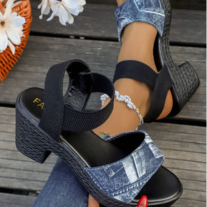 Denim-patterned high block heel sandals with black elastic straps and a textured sole.