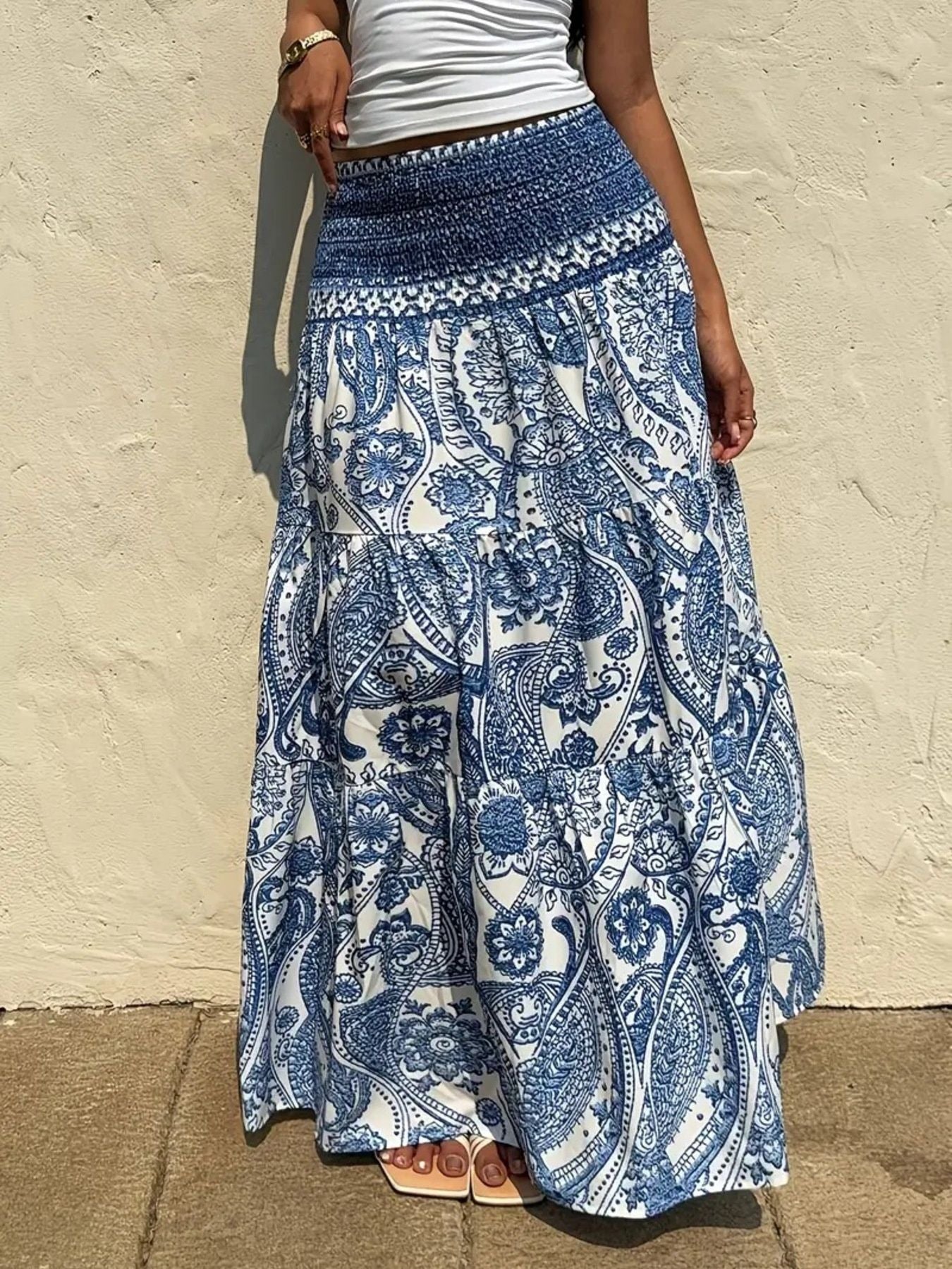 Bohemian paisley maxi skirt in blue with smocked waist and tiered ruffles.