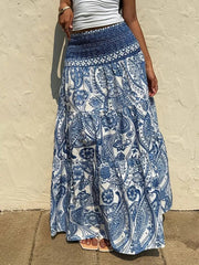 Bohemian paisley maxi skirt in blue with smocked waist and tiered ruffles.