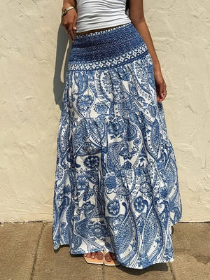 Bohemian paisley maxi skirt in blue with smocked waist and tiered ruffles.