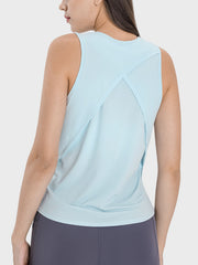 Light blue performance tank top with a cross-back detail and sheer panel.