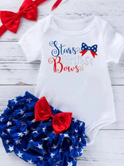 White baby onesie with red and blue "Stars & Bows" graphic and blue star-print ruffled bloomer with red bow.