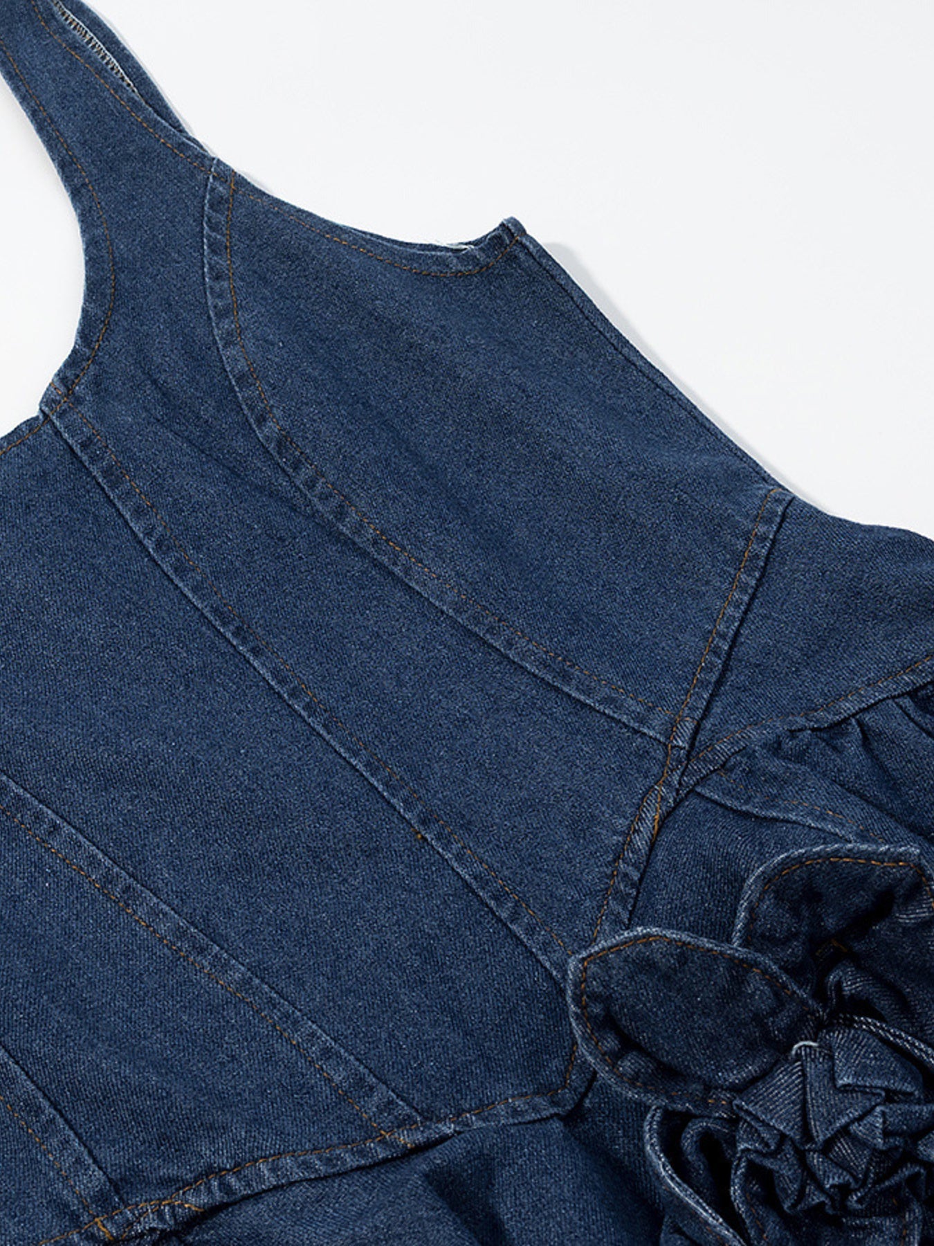 Denim mini dress with floral applique detail and ruffled hem.