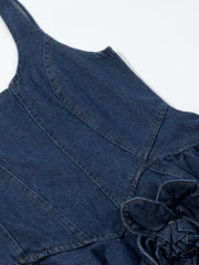Denim mini dress with floral applique detail and ruffled hem.