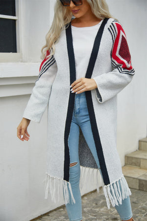 Long grey cardigan with black trim, geometric red and black sleeves, and fringed hemline.