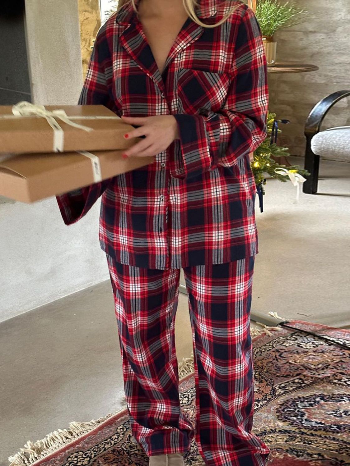 Crimson plaid pajama set with button-up top and pants, made of 100% polyester.