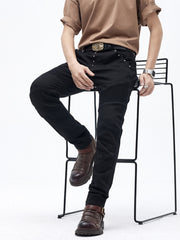 Black cotton slim fit moto jeans with ribbed panels and studded details.