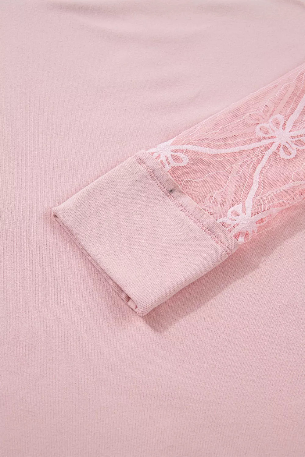 Pink maternity t-shirt with lace sleeves featuring a floral pattern and bow detail.