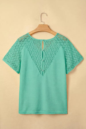 Teal waffle knit shirt with lace detail on sleeves and back, V-neck, short sleeves, button back detail.