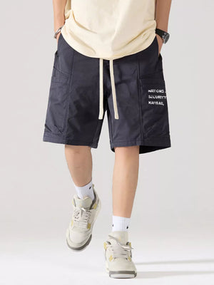 Navy blue cotton cargo shorts with adjustable drawstring and side pocket text detail.