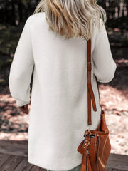 White fuzzy long sleeve cardigan with pockets, shown from the back.