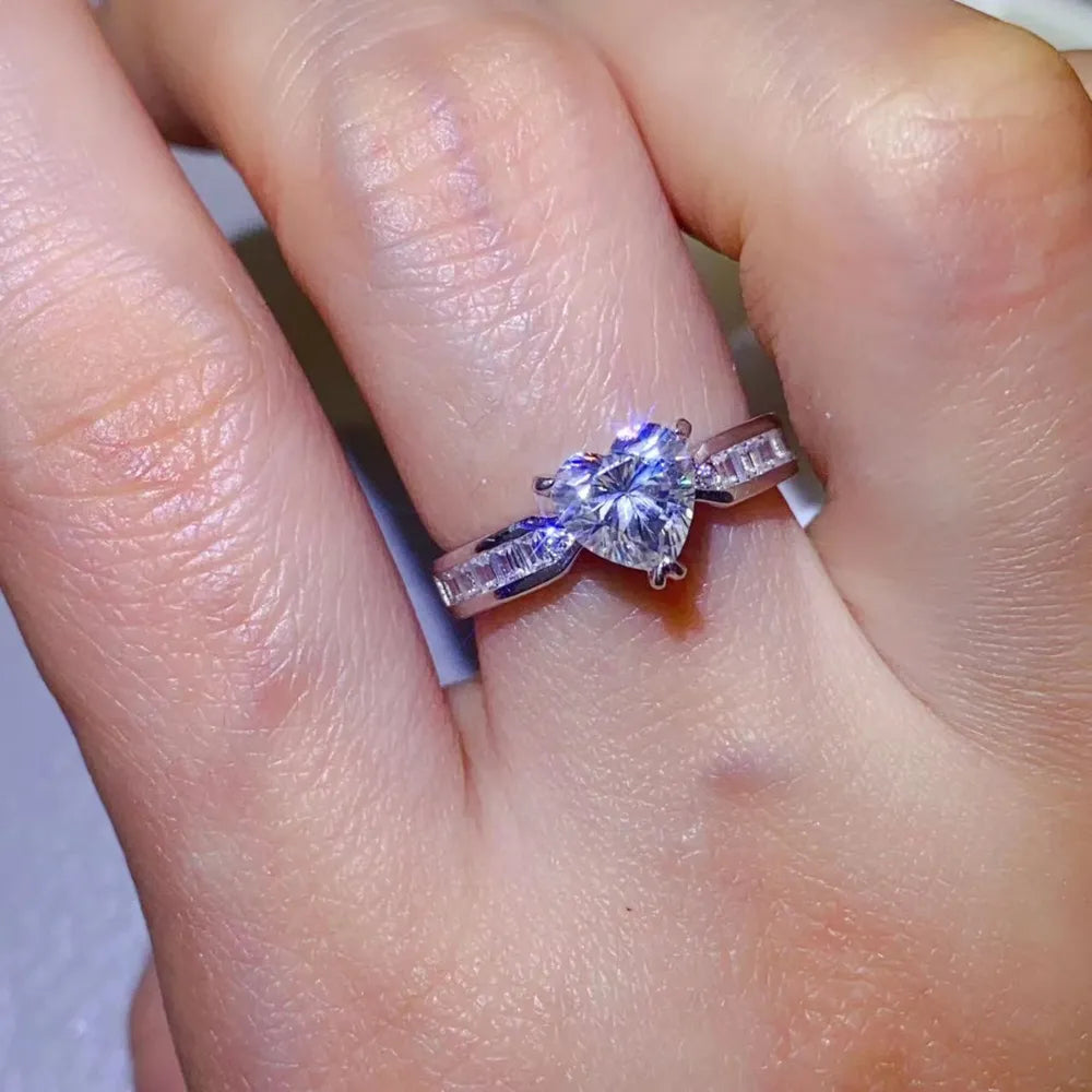 Silver ring with heart-cut moissanite and baguette accents
